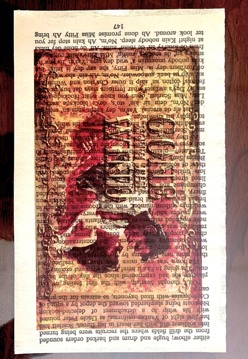 May include: A vintage book with a red and gold design on the cover. The book is open to a page with text and a faded image of a woman in a red dress. The text on the page reads "147".