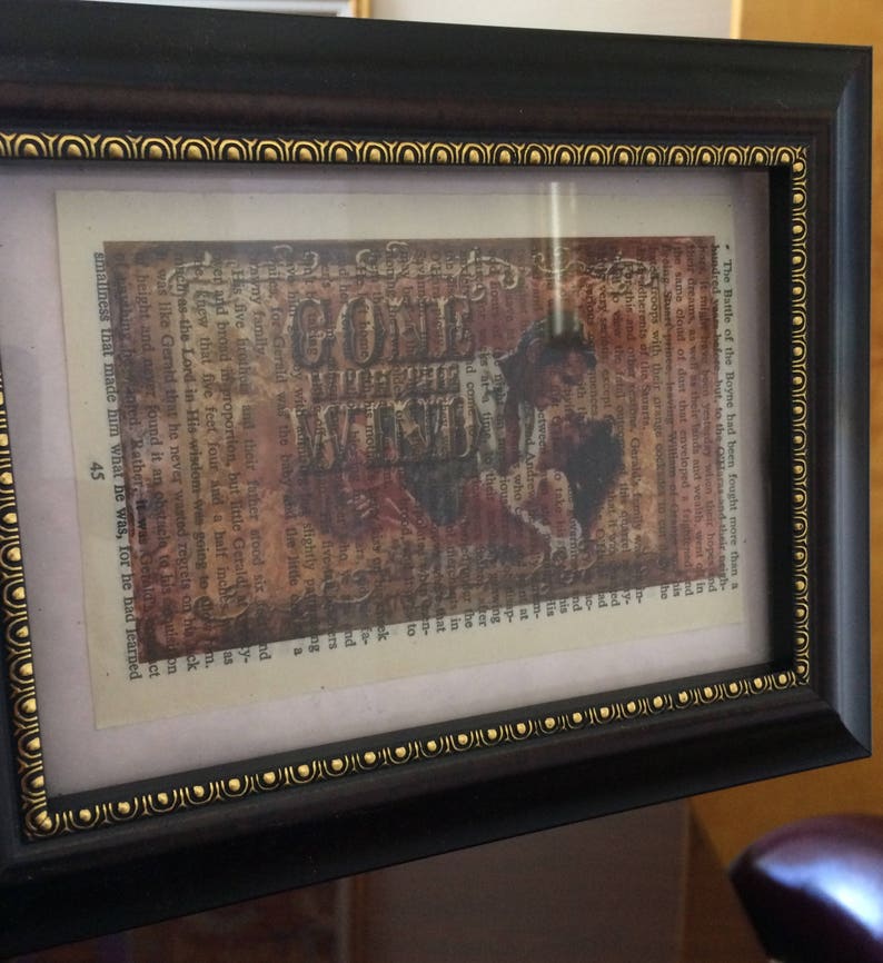 May include: A framed print with a vintage aesthetic featuring a collage of text and images. The text includes the words "Gone With The Wind" and "The Battle of the Boyne". The image is a sepia-toned portrait of a couple.