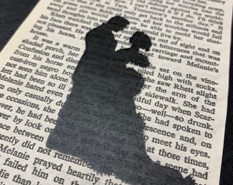 May include: A black silhouette of a couple embracing on a vintage book page. The text on the page is visible, including the words "another day" and "Rhett alight".