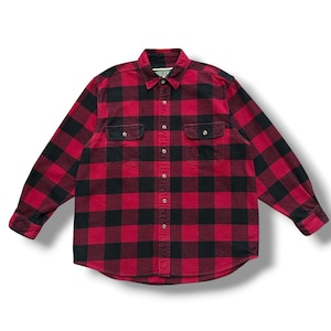 May include: A red and black checked flannel shirt with two chest pockets and a button-down front. The long-sleeved shirt is made of a soft, woven fabric. The shirt is a classic style, suitable for casual wear.