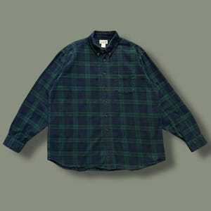 May include: A set of three ceramic mugs with a speckled, matte finish. The mugs are in shades of cream, light gray, and dark gray. Each mug has a simple, minimalist design, perfect for coffee or tea.