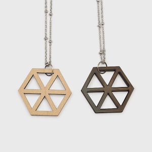 May include: Two geometric wooden pendant necklaces with silver chains. One pendant is natural wood and the other is stained dark brown.