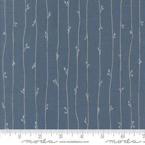 May include: Blue fabric with a white, vertical, repeating pattern of thin stems with small leaves. The fabric has a subtle texture and is marked with a ruler in inches.