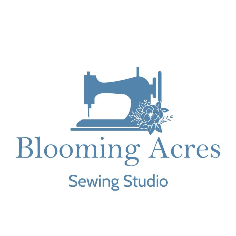 May include: A logo for Blooming Acres Sewing Studio. The logo features a blue sewing machine silhouette with floral accents. The text "Blooming Acres" and "Sewing Studio" are in blue, set against a white background.