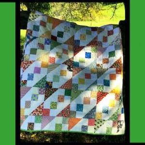 May include: A colorful quilt pattern with a white background and a variety of colors, including red, blue, green, yellow, and orange. The quilt is called "Giggles" and is designed by Tricia Lynn Maloney for Villa Rosa Designs.