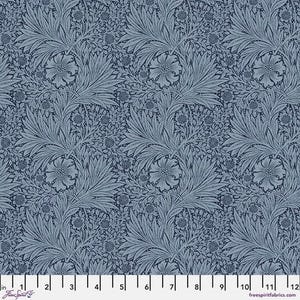 May include: A fabric with a repeating floral pattern in shades of blue. The design features stylized flowers and foliage, creating a classic, detailed look. The fabric is measured in inches along the bottom edge.
