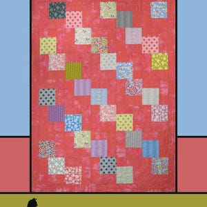 May include: A quilt titled "Cascade" with a red background and a pattern of colorful squares. The squares feature various designs, including polka dots and floral prints. The quilt is designed by Melissa Milligan for Villa Rosa Designs.