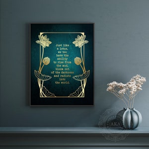 May include: Framed wall art with a teal background and gold lotus flower design. The text reads: "Just like a lotus, we too have the ability to rise from the mud, bloom out of the darkness and radiate into the world."