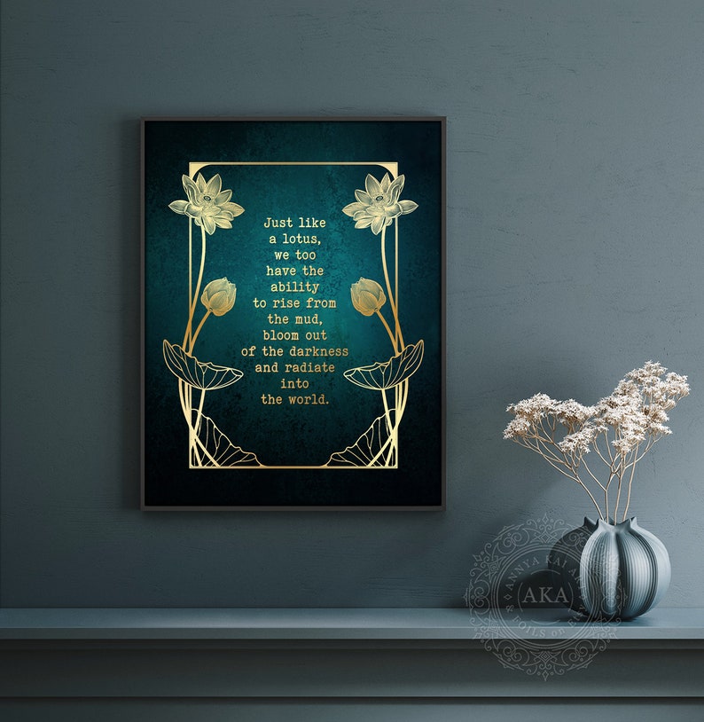 May include: Framed wall art with a teal background and gold lotus flower design. The text reads: "Just like a lotus, we too have the ability to rise from the mud, bloom out of the darkness and radiate into the world."