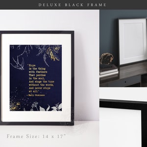 May include: A black framed print with a navy blue background and gold lettering. The print features a quote by Emily Dickinson about hope. The frame is 14 inches by 17 inches.