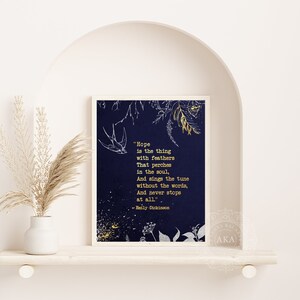 May include: A navy blue printable art print with a gold quote by Emily Dickinson about hope. The quote is surrounded by gold glitter and a white floral design.