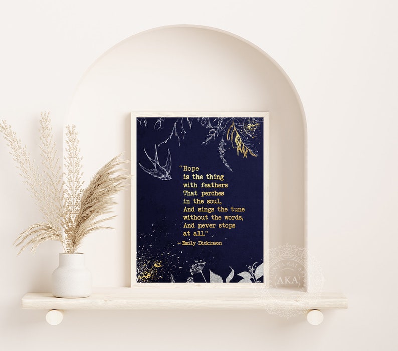 May include: A navy blue printable art print with a gold quote by Emily Dickinson about hope. The quote is surrounded by gold glitter and a white floral design.