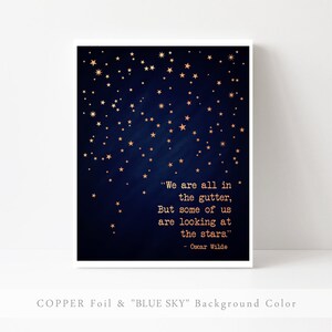May include: A navy blue background with gold stars and a quote by Oscar Wilde: "We are all in the gutter, But some of us are looking at the stars." The text is in a typewriter font.