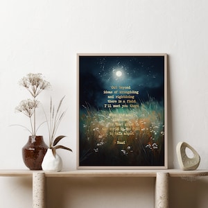 May include: A framed print with a dark blue background and a moon in the sky. The print features a quote in gold lettering that reads: "Out beyond ideas of wrongdoing and rightdoing there is a field. I'll meet you there. When the soul lies down in that grass the world is too full to talk about." -Rumi
