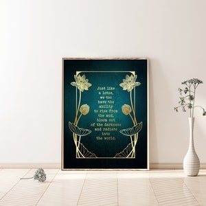 May include: Framed art print with a teal background and gold lotus flower illustrations. The text reads, "Just like a lotus, we too have the ability to rise from the mud, bloom out of the darkness and radiate into the world."