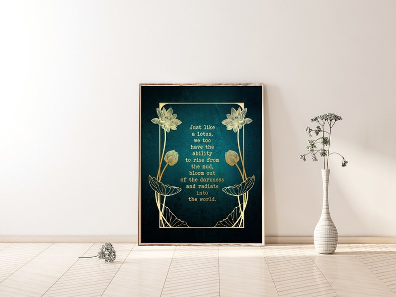 May include: Framed art print with a teal background and gold lotus flower illustrations. The text reads, "Just like a lotus, we too have the ability to rise from the mud, bloom out of the darkness and radiate into the world."