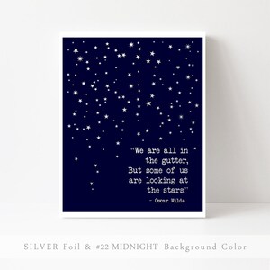 May include: A navy blue printable art print with silver foil stars and a quote by Oscar Wilde: "We are all in the gutter, but some of us are looking at the stars."