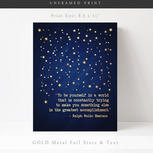May include: An 8.5 by 11 inch unframed print with a dark blue background and gold foil stars. The print features a quote by Ralph Waldo Emerson: "To be yourself in a world that is constantly trying to make you something else is the greatest accomplishment."
