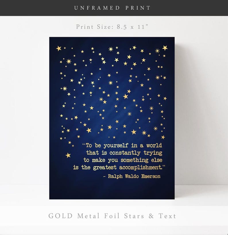May include: An 8.5 by 11 inch unframed print with a dark blue background and gold foil stars. The print features a quote by Ralph Waldo Emerson: "To be yourself in a world that is constantly trying to make you something else is the greatest accomplishment."