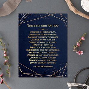 May include: A navy blue card with gold geometric shapes and gold text. The text reads "This is my wish for you" and includes a quote by Ralph Waldo Emerson: "Comfort on difficult days, smiles when sadness intrudes, rainbows to follow the clouds, laughter to kiss your lips, sunsets to warm your heart, hugs when spirits sag, beauty for your eyes to see, friendships to brighten your being, faith so that you can believe, confidence for when you doubt, courage to know yourself, patience to accept the truth, love to complete your life." - Ralph Waldo Emerson