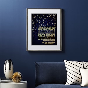 May include: A navy blue framed print with gold stars and a quote by Ralph Waldo Emerson. The quote reads: "To laugh often and much, to win the respect of intelligent people and the affection of children... This is to have succeeded."