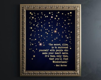May include: A framed wall art print featuring a dark blue background with scattered gold stars. The text reads: "The secret, Alice, is to surround yourself with people who make your heart smile. It's then, only then, that you'll find Wonderland." - Mad Hatter.