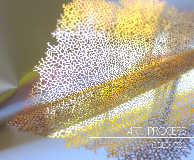 May include: A close-up of a gold foil design with a delicate, intricate pattern. The foil is folded and layered, creating a three-dimensional effect. The text "ART PROCESS GOLD FOIL" is visible at the bottom of the image.