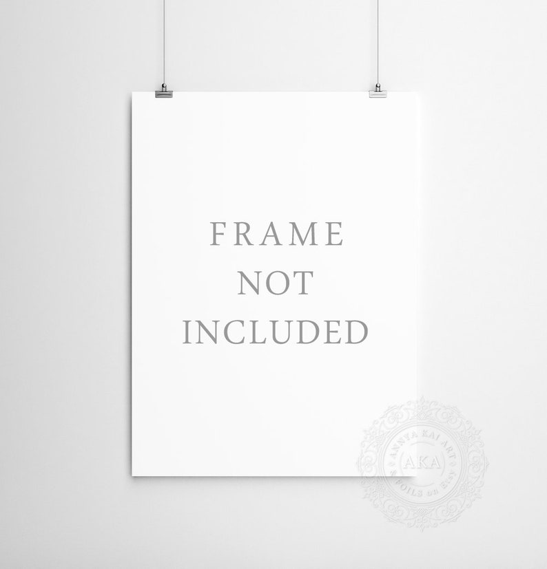 May include: A white poster with the text "FRAME NOT INCLUDED" printed in gray. The poster is hanging on a white wall with two silver clips.