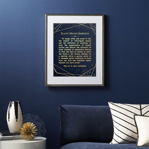 May include: A navy blue framed print with a gold quote by Ralph Waldo Emerson. The quote is about finding joy in life and leaving the world a better place. The background of the print is a dark blue with gold stars and geometric shapes.