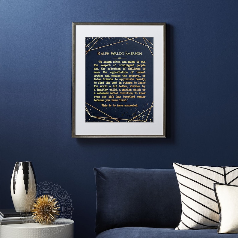 May include: A navy blue framed print with a gold quote by Ralph Waldo Emerson. The quote is about finding joy in life and leaving the world a better place. The background of the print is a dark blue with gold stars and geometric shapes.