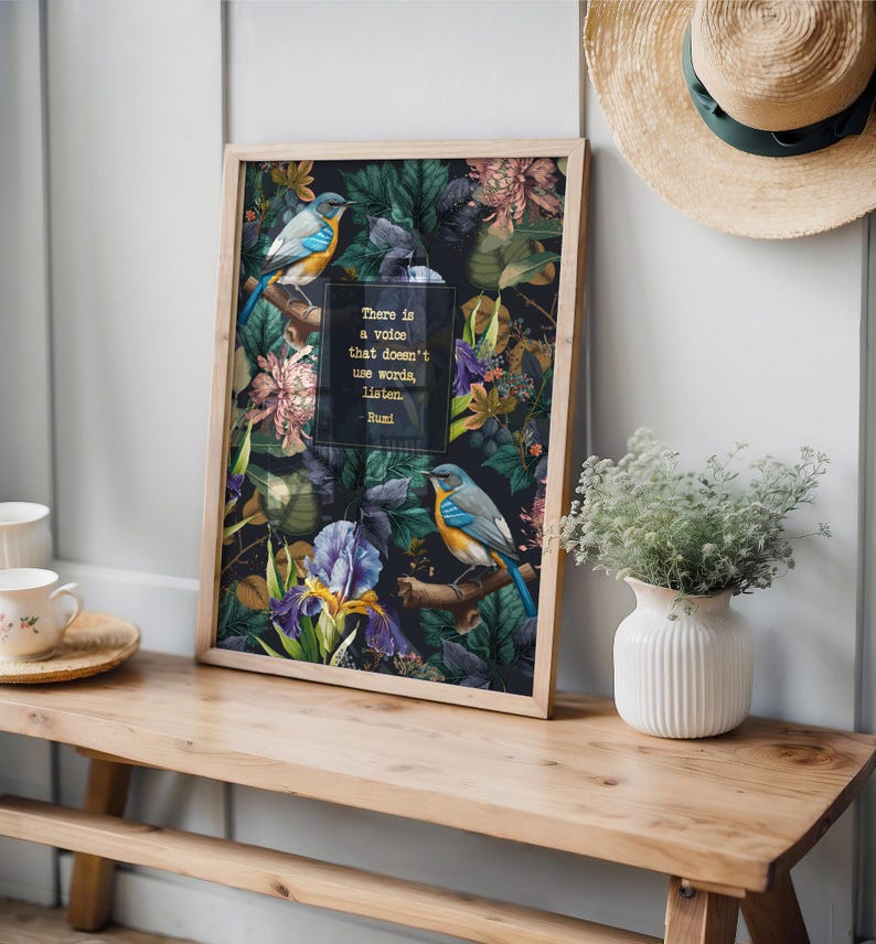 May include: A framed print with a dark background featuring a floral pattern with birds and a quote by Rumi: "There is a voice that doesn't use words, listen."