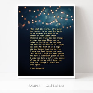 May include: A dark blue printable art print with a quote by F. Scott Fitzgerald about life and time. The quote is written in gold foil text and is surrounded by a string of white lights against a dark blue background.