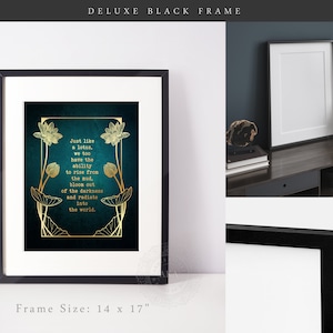 May include: A framed art print with a black frame and white matting. The artwork features a teal background with gold lotus flower illustrations and text that reads, "Just like a lotus, we too have the ability to rise from the mud, bloom out of the darkness and radiate into the world." Frame size is 14 x 17 inches.