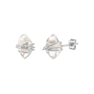 Herkimer Diamond Stud Earrings in sterling silver wire and matching sterling silver push back closures. The quartz crystals are wrapped three times in sterling silver wire for a secure fit. The natural quartz crystals are transparent and colorless.