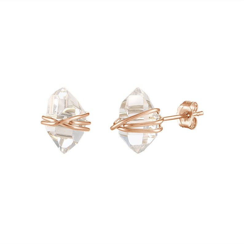 Herkimer Diamond Stud Earrings in rose gold wire and matching rose gold push back closures. The quartz crystals are wrapped three times in rose gold wire for a secure fit. The quartz crystals are transparent, colorless, and naturally faceted.