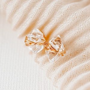 Herkimer Diamond Stud Earrings. Quartz crystals wrapped three times in gold wire for completed post earrings. The quartz crystals are transparent, colorless, and naturally faceted. They are double-terminated crystals (pointed on both ends).
