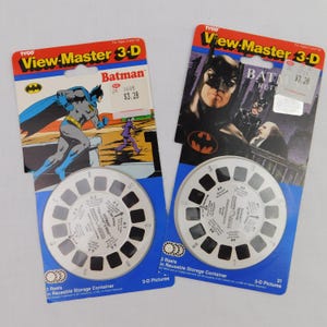 May include: Two vintage View-Master 3-D reels featuring Batman. One reel shows Batman in action with the Joker, and the other features Batman Returns. Each reel includes a 3-D picture storage container.