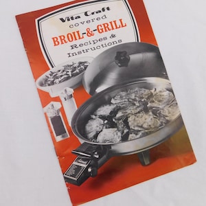 May include: A vintage Vita Craft covered BROIL-&-GRILL cookbook with recipes and instructions. The image shows a stainless steel grill with a lid, a bowl of food, and salt and pepper shakers. The cookbook has a red and white cover.
