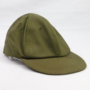 May include: Olive green baseball cap with a curved brim. The cap has a six-panel design with two small ventilation holes on the crown. The cap is made of a durable, solid-colored fabric.