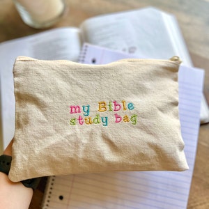 May include: A beige canvas zippered pouch with the words "my Bible study bag" embroidered in colorful letters.
