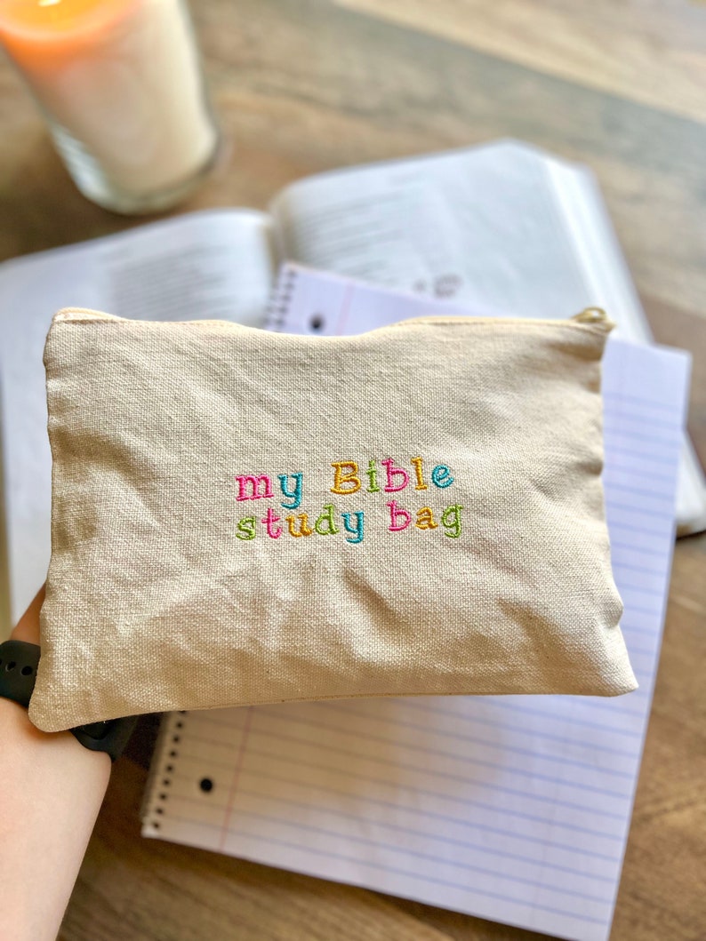 May include: A beige canvas zippered pouch with the words "my Bible study bag" embroidered in colorful letters.