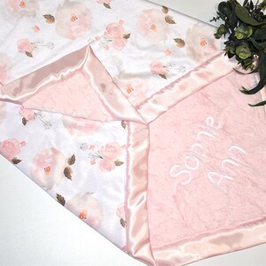 Celebrate the arrival of a baby girl with this pink minky baby blanket, offering unparalleled comfort and style.