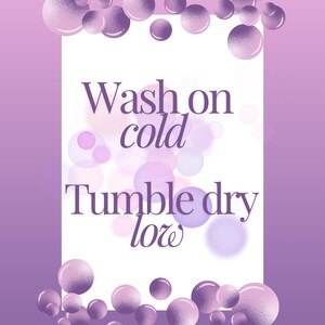 May include: Purple and white graphic with a white background and purple text that reads "Wash on cold Tumble dry low" surrounded by purple and white circles.
