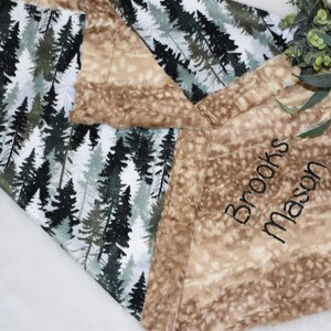 Cherish the joy of parenthood with a charming woodland baby gift in shades of green. The personalized deer blanket exudes warmth, making it a wonderful shower surprise