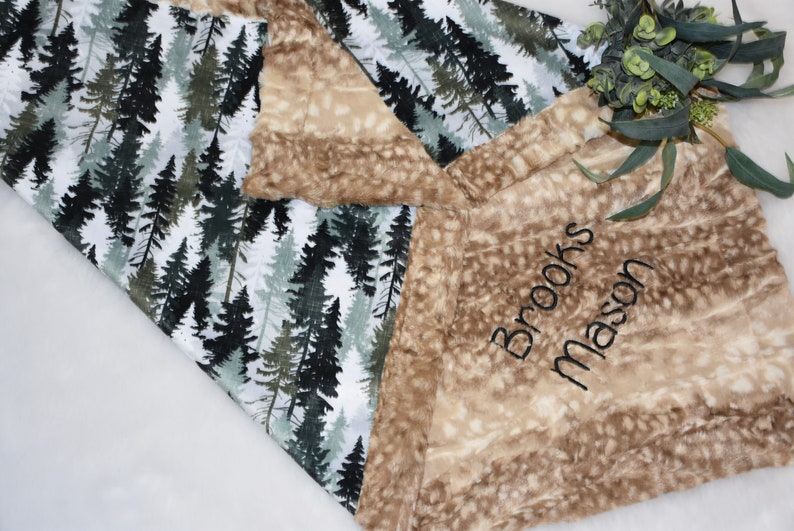 Cherish the joy of parenthood with a charming woodland baby gift in shades of green. The personalized deer blanket exudes warmth, making it a wonderful shower surprise