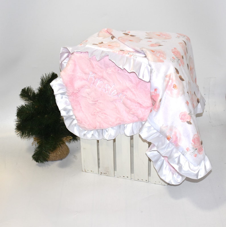 Embrace the charm of a baby girl's nursery with this beautifully designed soft pink minky blanket, the perfect gift for new parents.