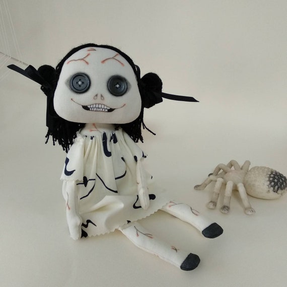 creepy girl with black hair and doll