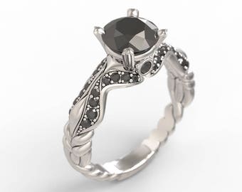 May include: A silver engagement ring with a black diamond center stone and black diamond accents on the band.
