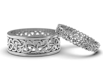 May include: Two silver Celtic knot wedding bands. The wider band has a more intricate design.