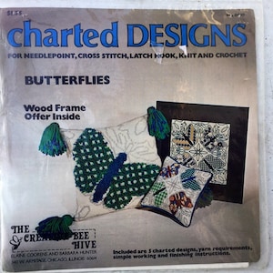 May include: A vintage needlepoint kit featuring five butterfly designs. The kit includes yarn requirements, simple working and finishing instructions, and a wood frame offer. The kit is titled "Butterflies" and is from "The Creative Bee Hive".
